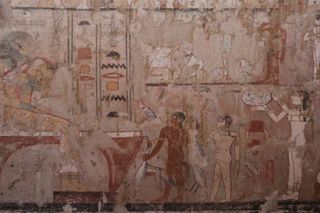 The tomb contains well preserved wall paintings, including this image showing fish and other goods being presented to Hetpet, who is shown seated at the far left. 