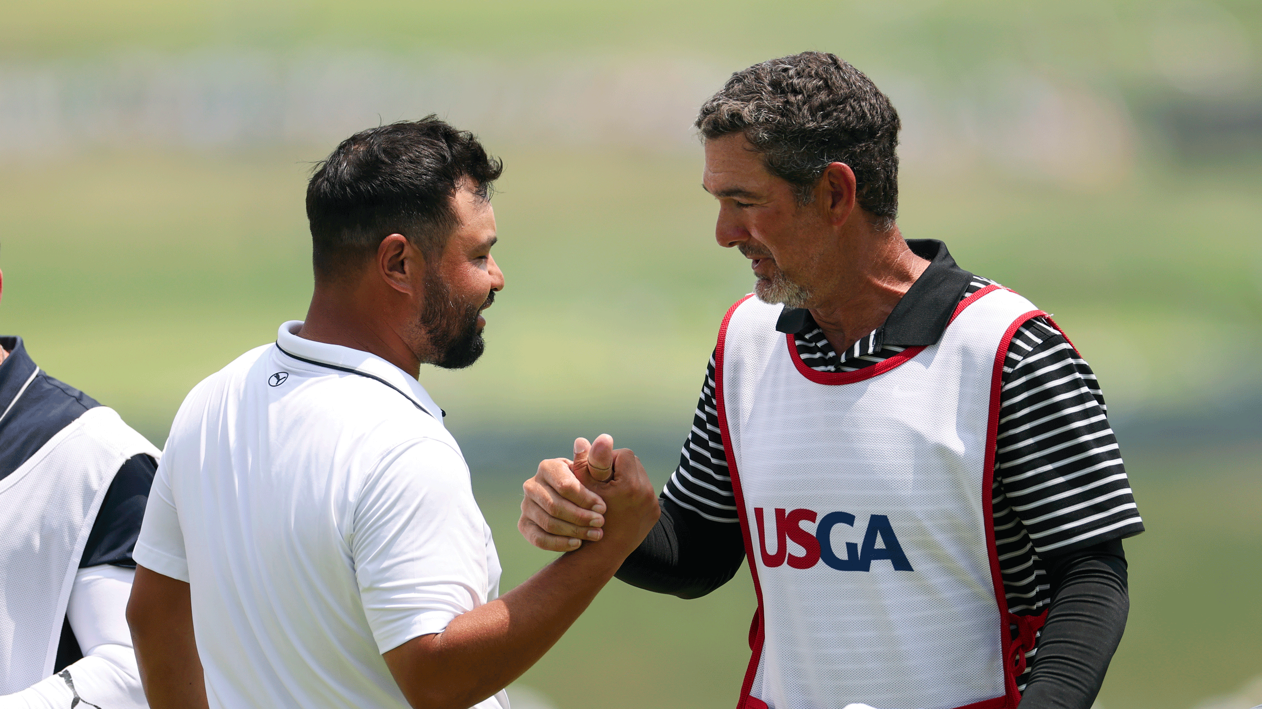 JJ Spaun and Paul Tesori shake hands during the 2025 US Open at Oakmont