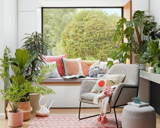 Biophilic design of living room with connection to landscape and lots of houseplants