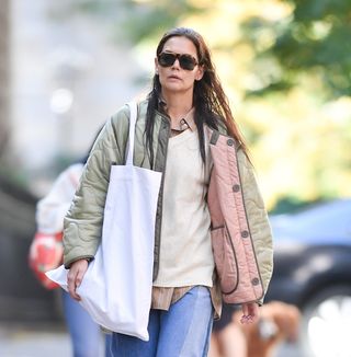 A closeup of Katie Holmes wearing a quilted jacket and three shirts.