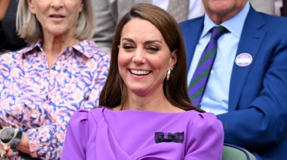 Catherine Princess of Wales laughing court-side of Centre Court during the men's final on day fourteen of the Wimbledon Tennis Championships at the All England Lawn Tennis and Croquet Club on July 14, 2024 in London, England.