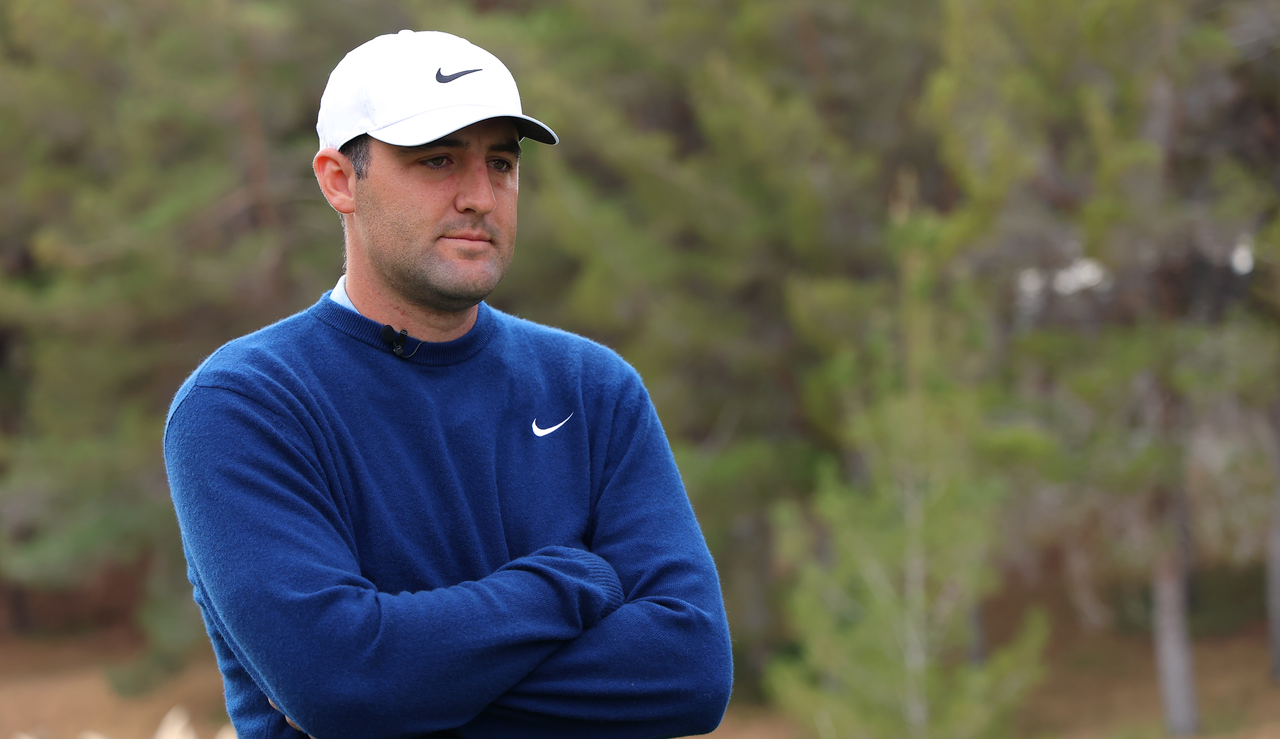 Scottie Scheffler stares on whilst standing on the first tee