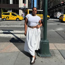 aniyah wears white tee and white linen dress with brown and white loafers