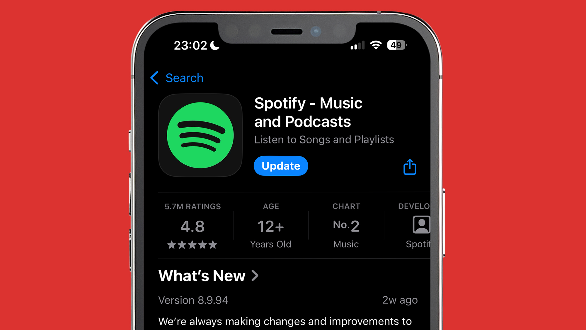 An iPhone on a red background showing the Spotify app being updated in the App Store.