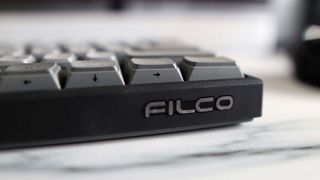 A Filco Majestouch MINILA-R gaming keyboard on a marble effect desk