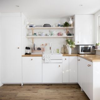 kitchen with white cabinets and shelves with cupboard