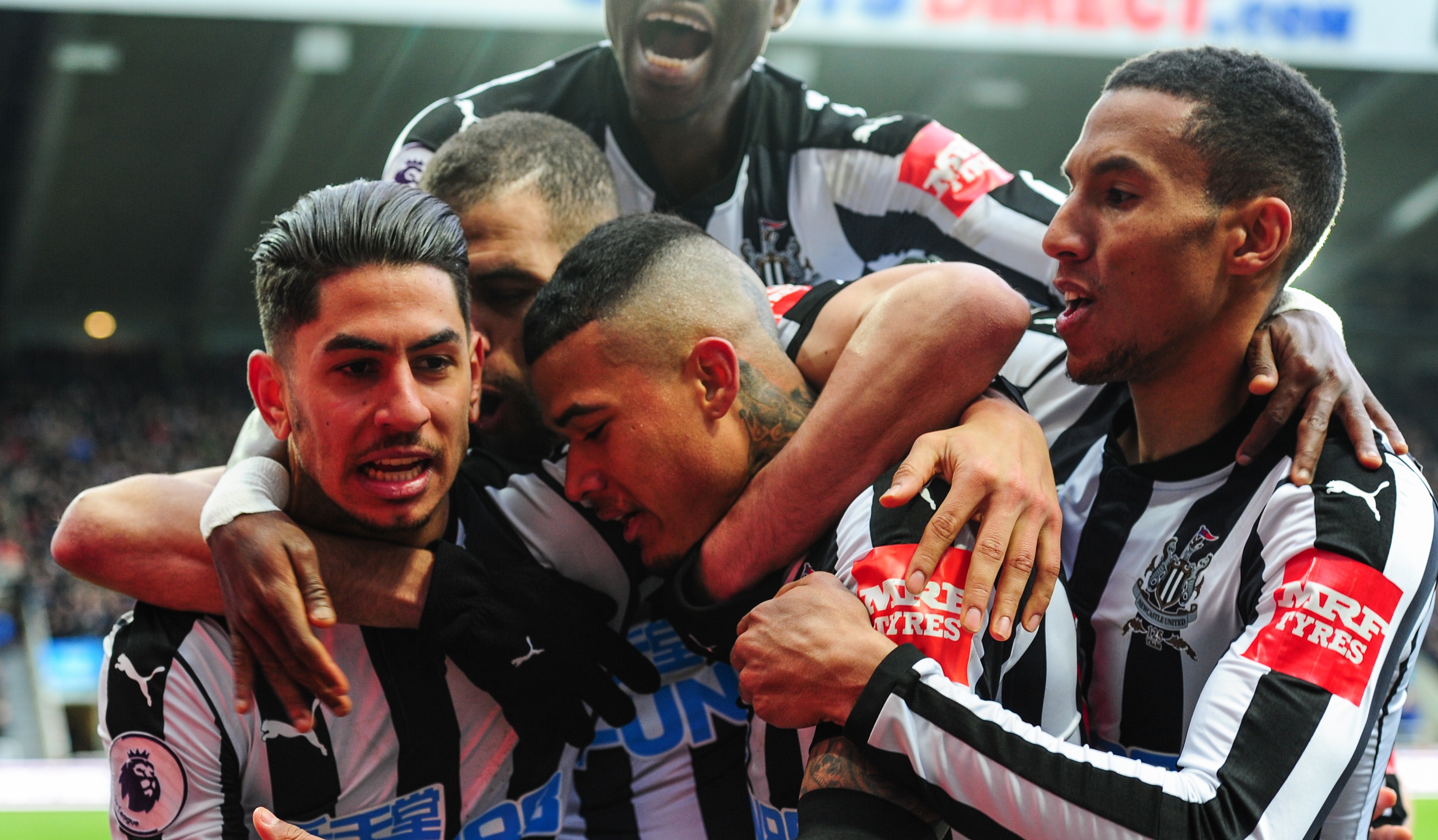 Ayoze Perez of Newcastle United (L) celebrates with team-mates after he scores in the Premier League game against Huddersfield Town at St.James' Park on March 31, 2018, in Newcastle upon Tyne, England