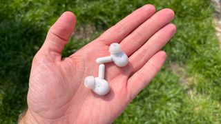 Urbanears Juno earbuds in a person's hand