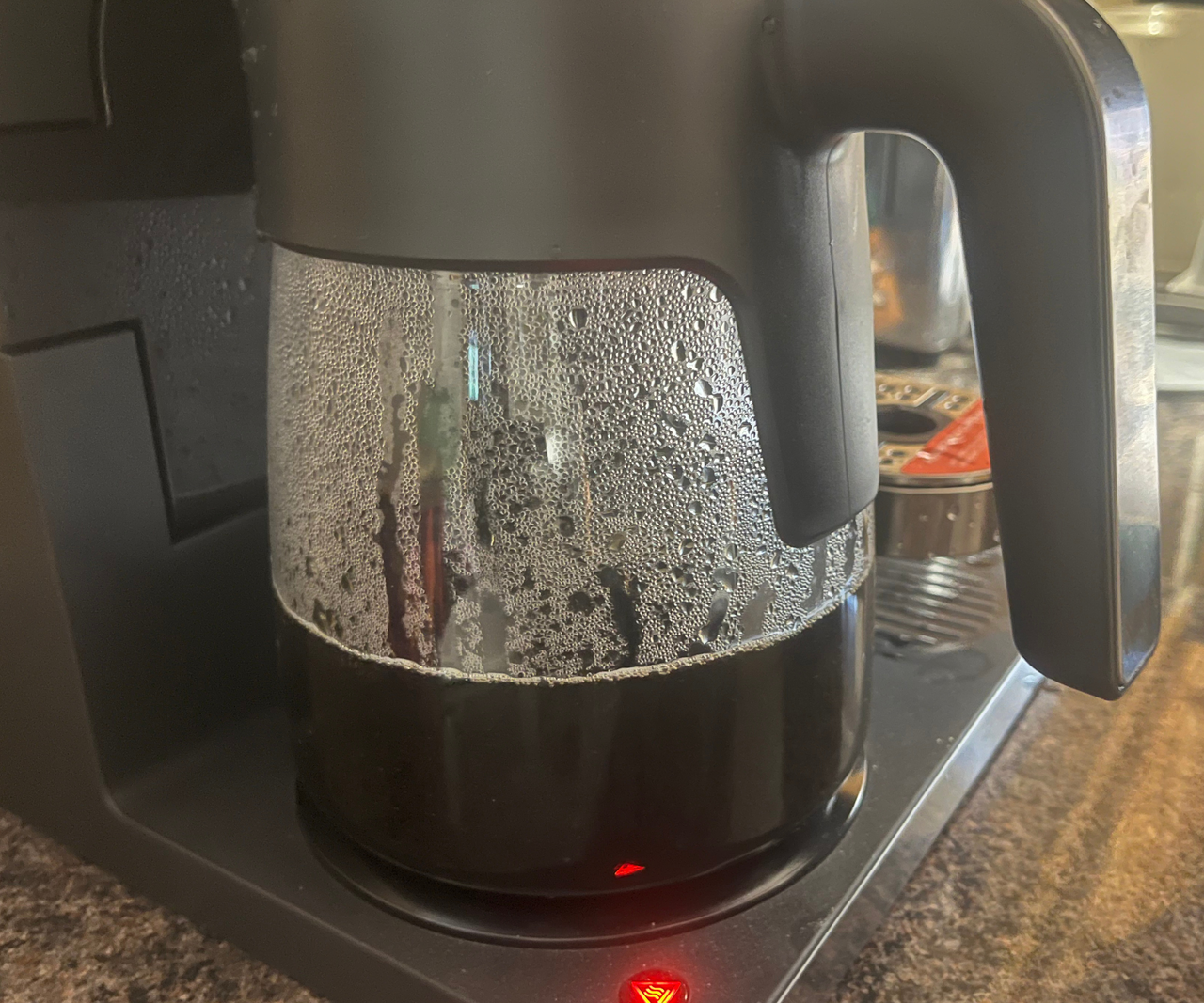 A closeup of a class carafe on a drip coffee maker hot plate.
