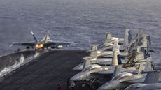 File photo of an F/A-18E Super Hornet launching from the flight deck of Nimitz-class aircraft carrier USS Abraham Lincoln (CVN 72)