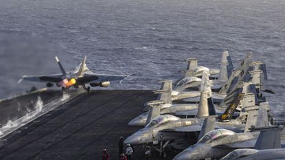File photo of an F/A-18E Super Hornet launching from the flight deck of Nimitz-class aircraft carrier USS Abraham Lincoln (CVN 72)