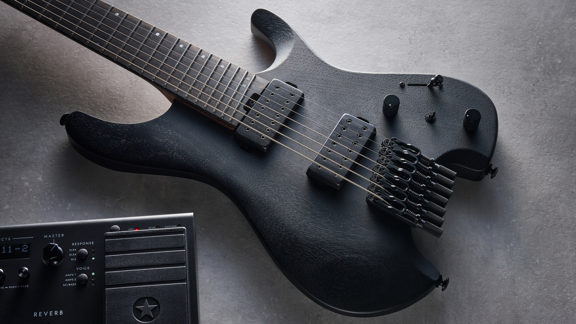 Ibanez QX527B headless guitar shot on grey surface