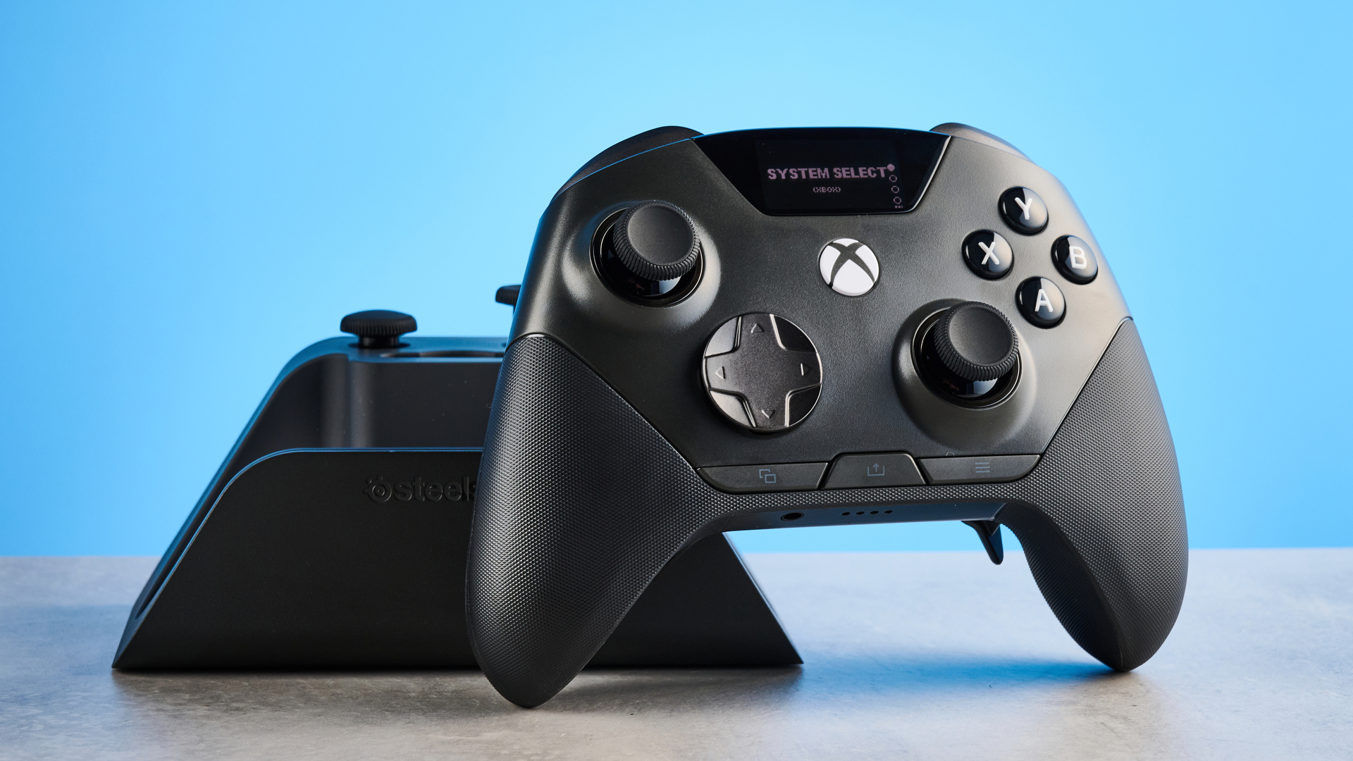 The SteelSeries Aeon Pro on a stone surface against a blue background