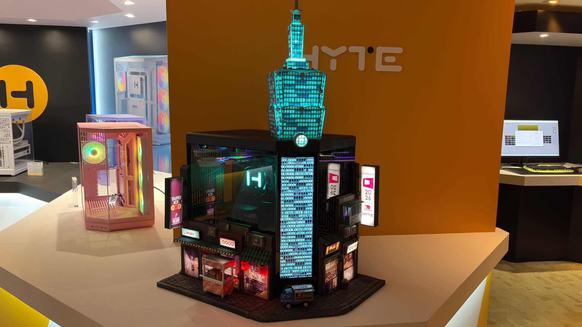 A tiny 3D printed Alex Honnold free solos up the side of a much bigger 3D printed recreation of the Taipei 101 building. The whole structure is built onto a Hyte Y70 Touch PC case.