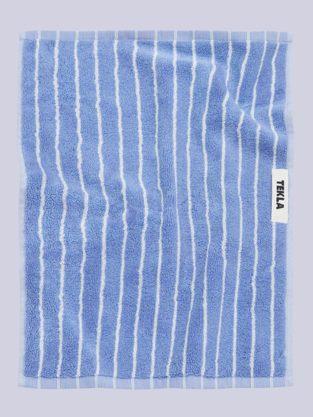 A blue and white striped towel from TEKLA