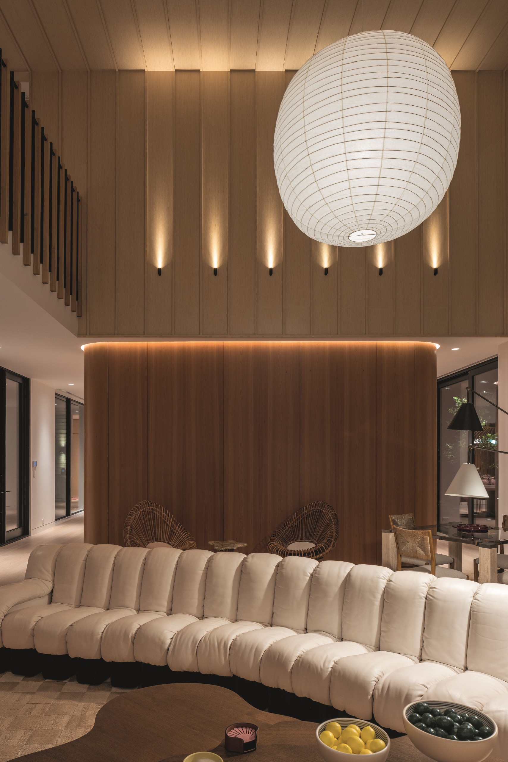 Theatrical interiors with art installation-like ceilings, a consistent yet striking palette, statement lighting in bold forms, and softly shaped furniture.