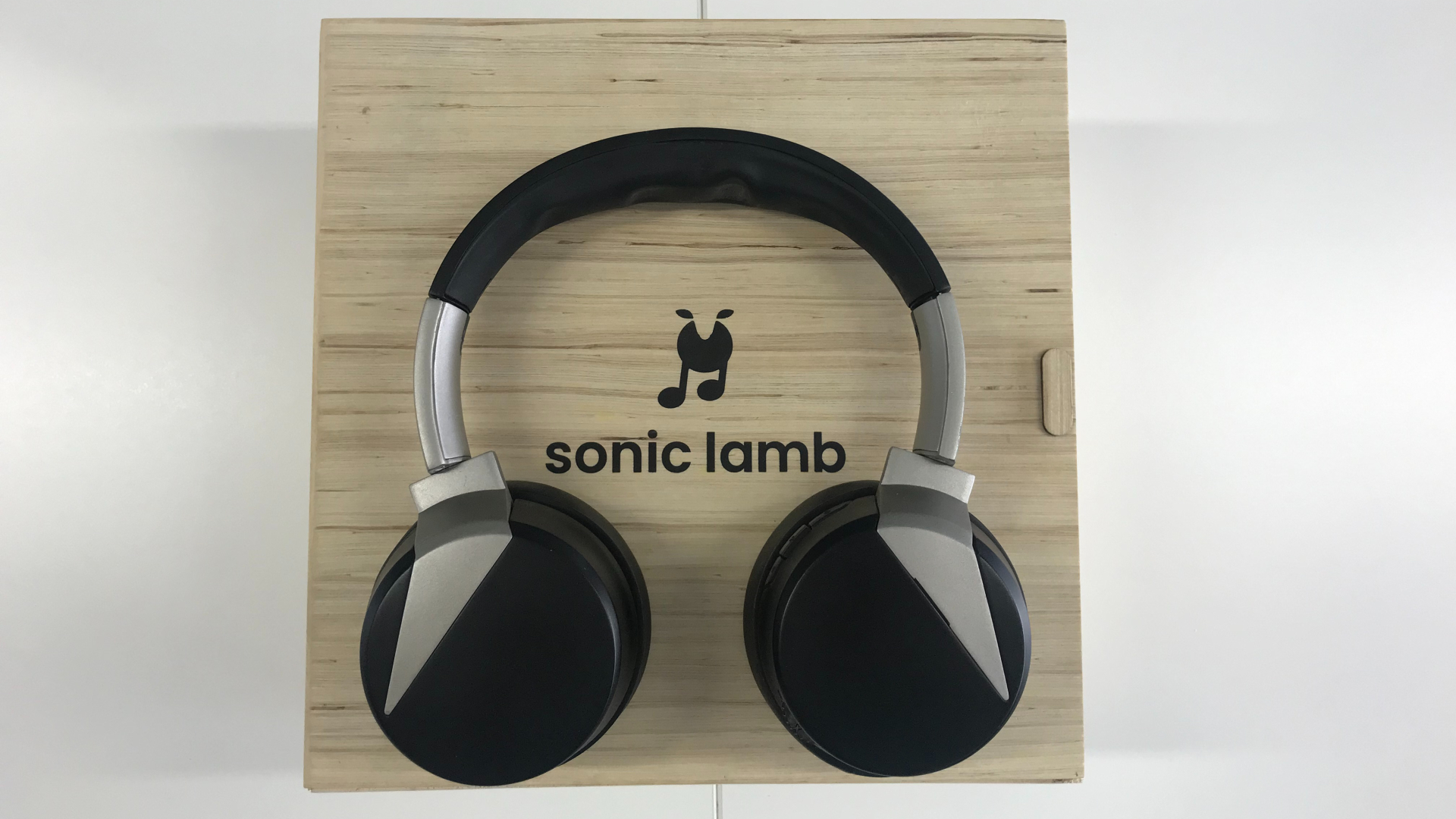 Sonic Lamb headphones on wooden box