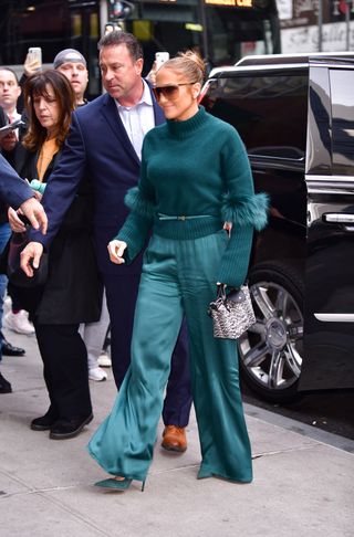 Jennifer Lopez carrying a Longchamp Le Pliage tote in New York City with a turquoise outfit