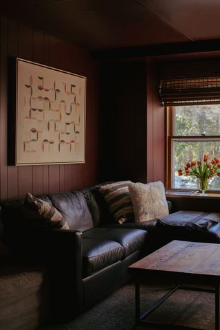 dark red walls with leather sofa