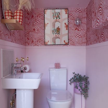 Pink downstairs bathroom with wallpaper