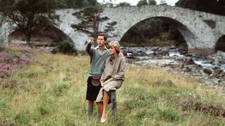 Prince Charles, Prince of Wales and Diana, Princess of Wales, wearing a suit designed by Bill Pashley, pose for a photo on the banks of the river Dee in the grounds of Balmoral Castle during their honeymoon on August 19, 1981 in Balmoral, Scotland. (Photo by Anwar Hussein/Getty Images)