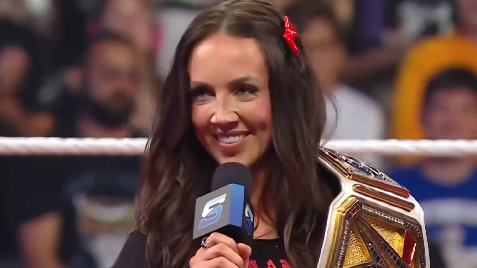 Chelsea Green talks into the microphone inside a WWE ring.