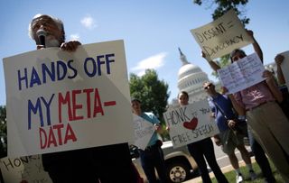 Protesters speak out against the NSA's collection of phone metadata.