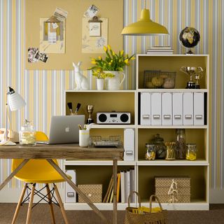 yellow home office with colourful storage and basket