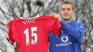 MANCHESTER, ENGLAND - JANUARY 9: Nemanja Vidic of Manchester United poses with a shirt at the press conference to announce his signing at Carrington Training Ground on January 9, 2006, in Manchester, England. (Photo by John Peters/Manchester United via Getty Images)