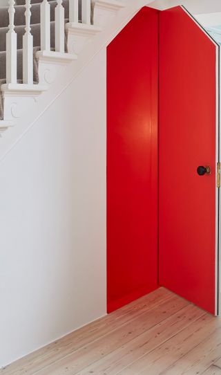 A under the stairs closet painted bright red