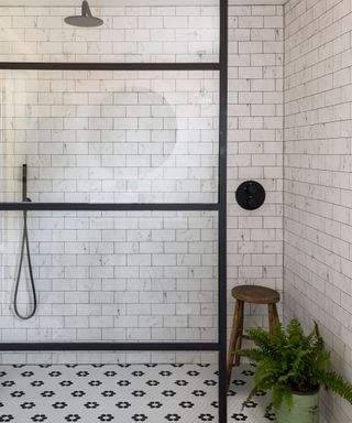 Blake Lively bathroom with shower cubicle and a patterned tiled wall