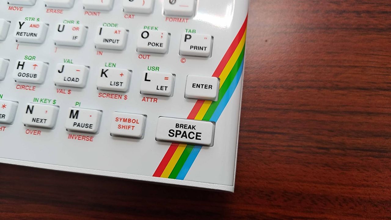 Close up of The Spectrum White Edition rainbow strip on keyboard plate.
