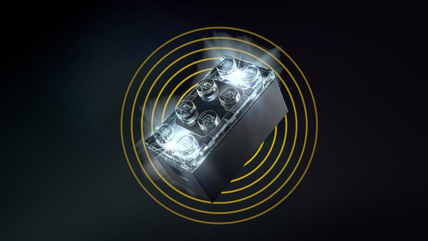 A black LEGO Smart Play brick, glowing and set against a black backdrop. 