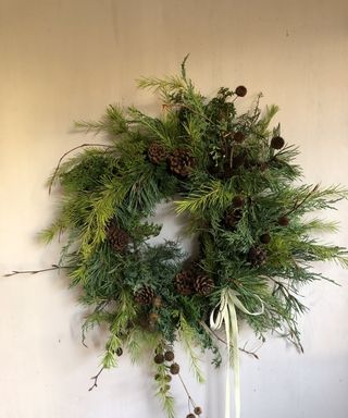 Natural Christmas wreath with pinecones and cream ribbon