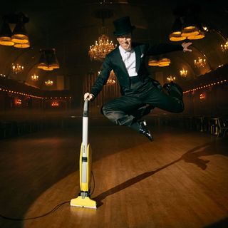 man dancing with vacuum