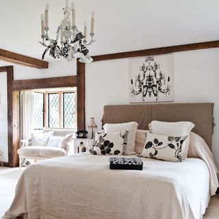 bedroom with chandelier and cushions