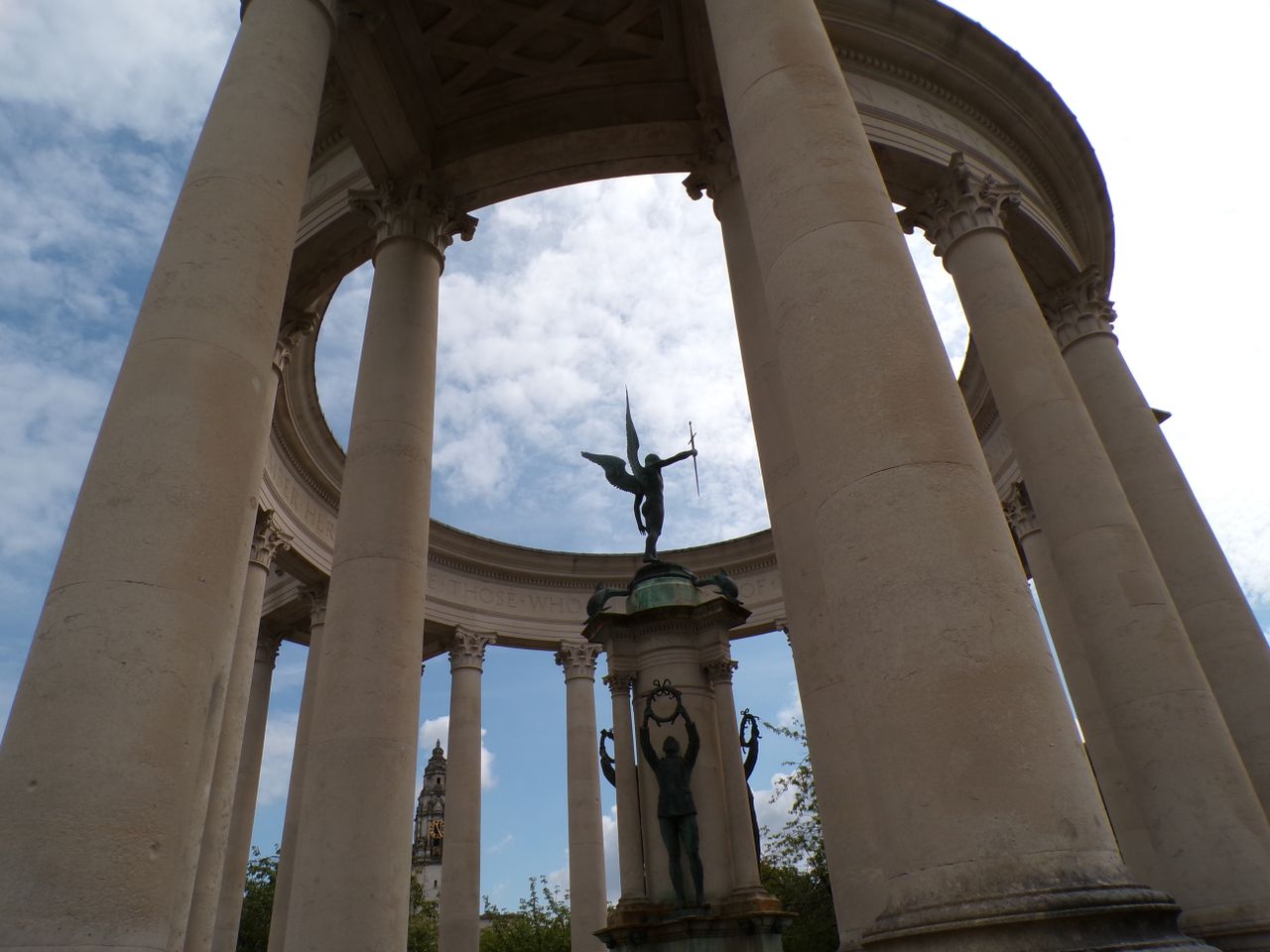 A statue of an angel surrounded by a stone monument