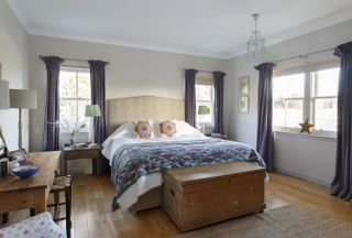 bedroom with wooden floor and decorative bedspread