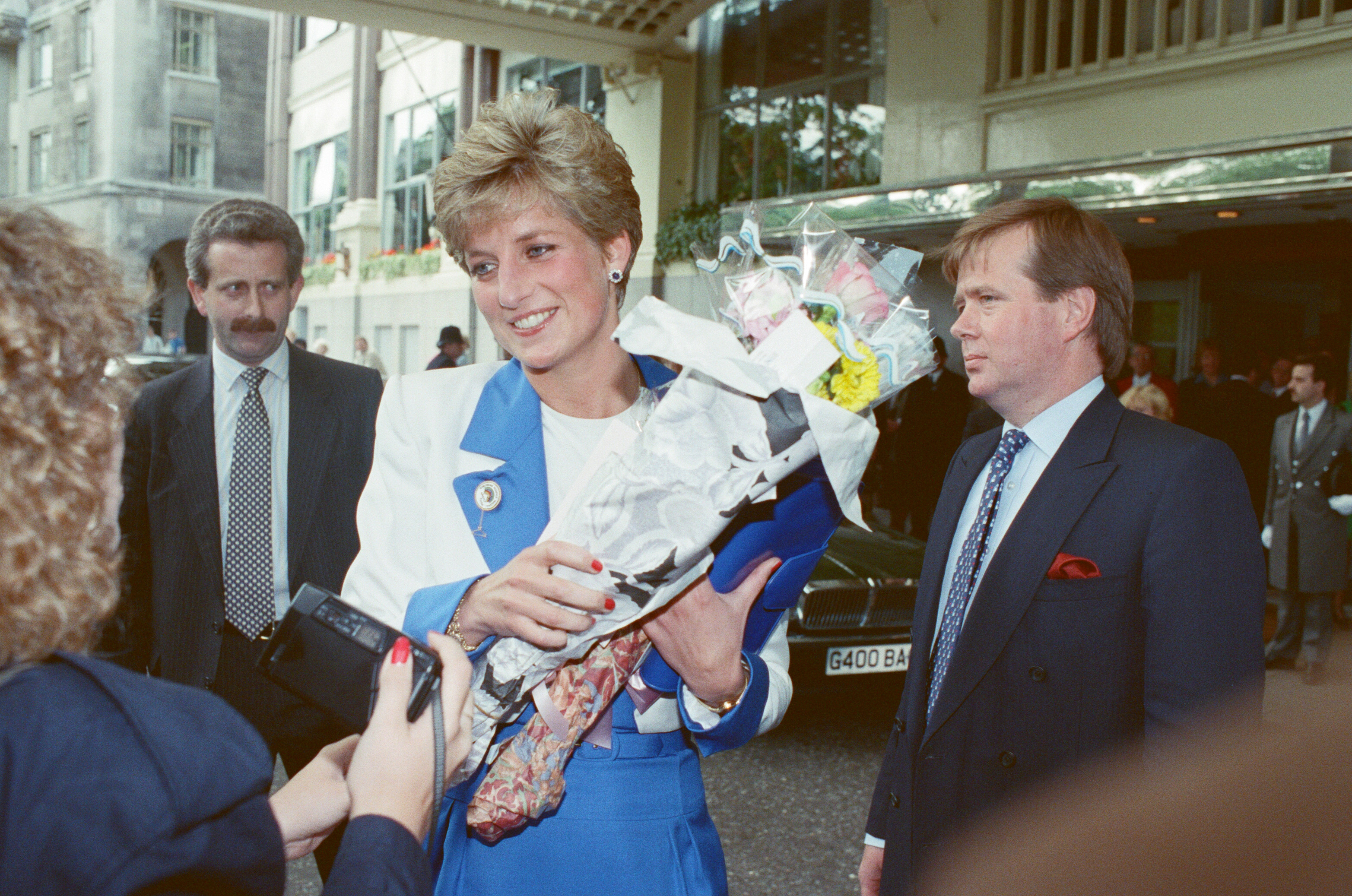 Princess Diana carrying flowers and talking to fans