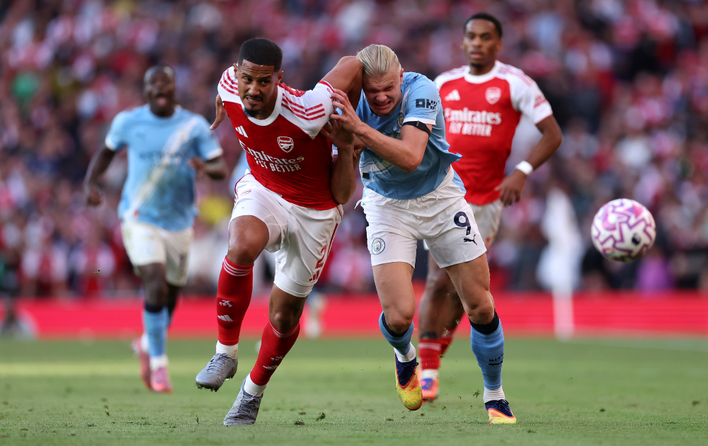 William Saliba of Arsenal battles for possession with Erling Haaland of Manchester City during the Premier League match between Arsenal and Manchester City at Emirates Stadium on September 21, 2025 in London, England.