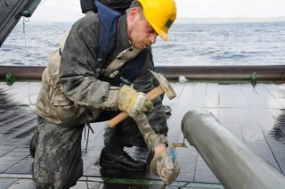 Hans roy opens a sediment core.