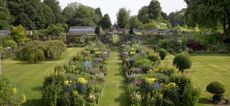 Looking down the mirrored herbaceous border in the gardens at Bramdean House.