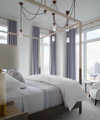 hotel style bedroom with a new york view and gray and white color scheme