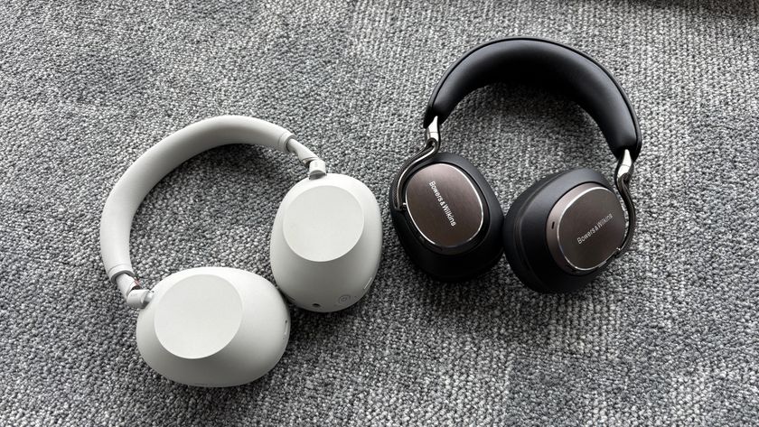 Bowers &amp; Wilkins Px8 S2 and Sony WH-1000XM6 headphones next to each other on a grey carpet.