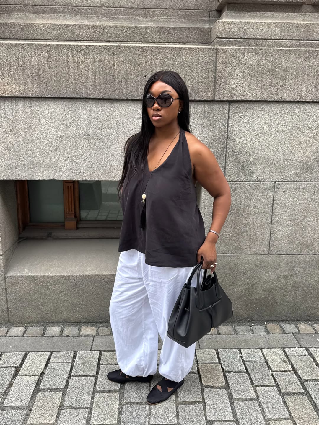 Influencer Nnenna Echem wearing sarouel trousers and sneakerinas.