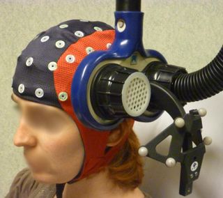 An image of the magnetic stimulation device applied over a localized brain area.