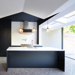 kitchen area with deep blue walls and worktop