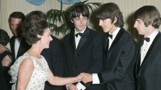 Princess Margaret shakes hands with George Harrison