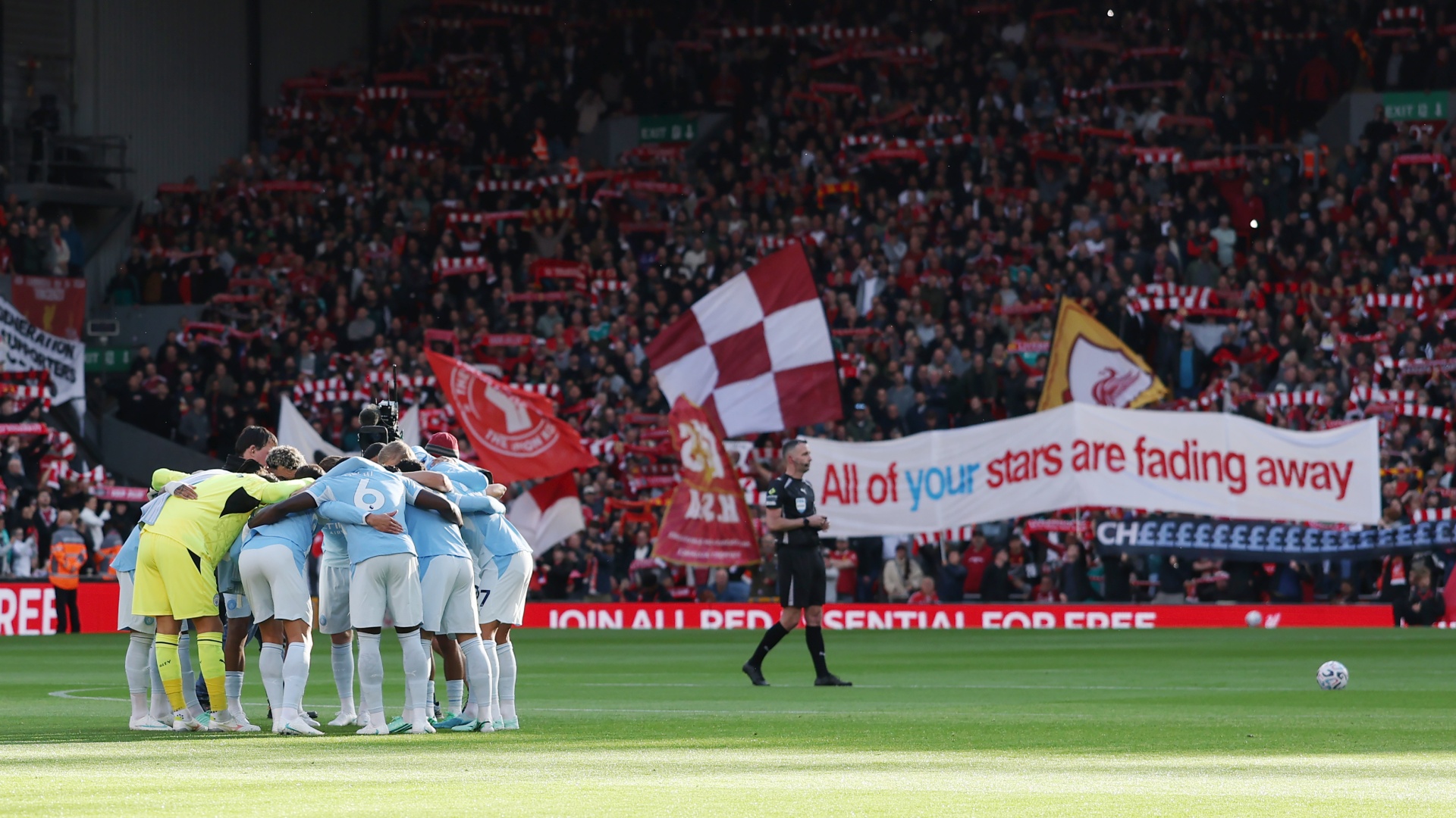 Man City huddle in front of a banner held by Liverpool fans reading "All of your stars are fading away" ahead of a Premier League 2026/27 game at Anfield on October 11, 2026