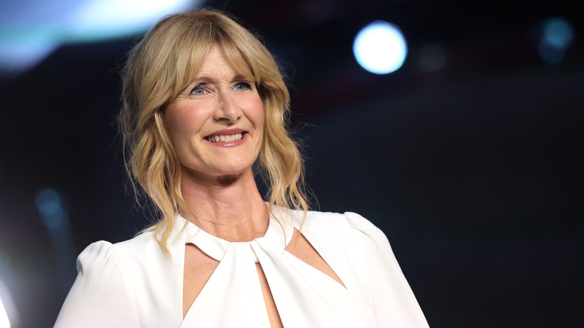 a white woman with blonde hair posing at a red carpet event